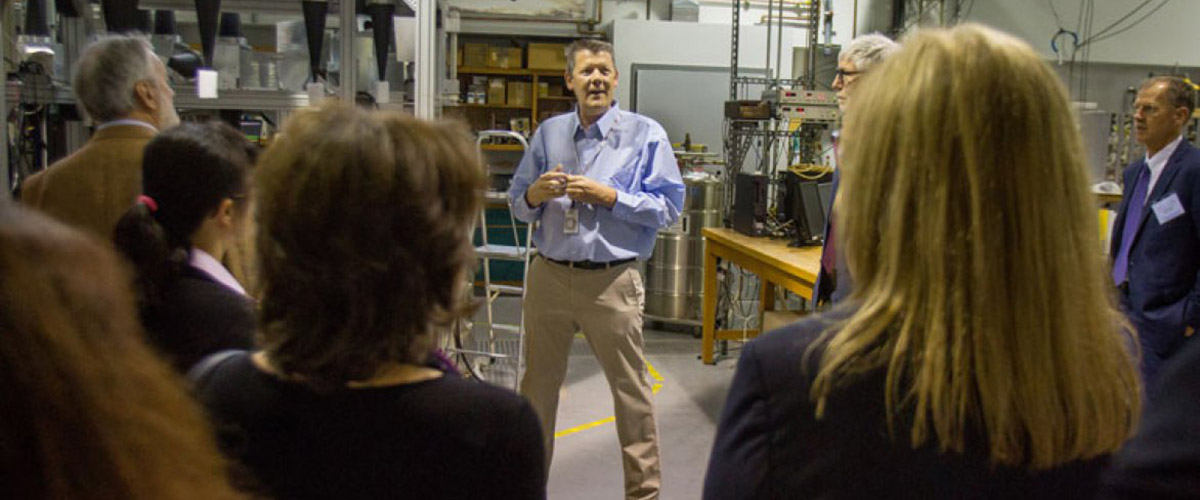 MagLab physicist Steve Hill gives a tour to participants of the 11th Meeting of the Group of Senior Officials for Global Infrastructures.