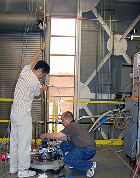 MagLab staffer Eun Sang Choi (left) assists West Virginia University scientist James Rall with an experiment in the Millikelvin Facility.