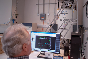 MagLab scientist analyzing data from 600 MHz 89 mm Wide Bore Bruker Avance Neo