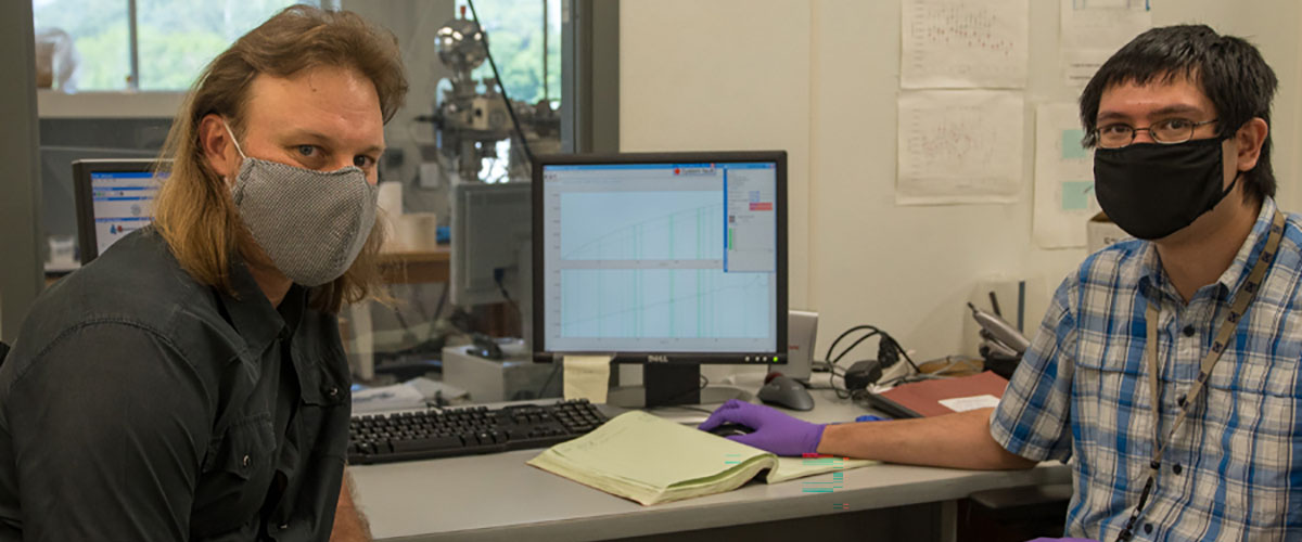 From left, Jeremy Owens, an associate professor in the FSU Department of Earth, Ocean and Atmospheric Science, and Sean Newby, a graduate research assistant, analyzing thallium isotopes on instruments at the National High Magnetic Field Laboratory.