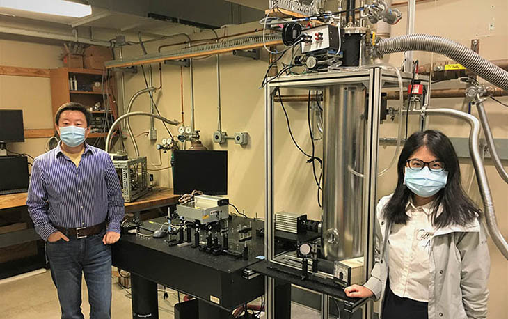 From left, Wei Guo, an associate professor of mechanical engineering at the FAMU-FSU College of Engineering, and Yuan Tang, a postdoctoral researcher at the National High Magnetic Field Laboratory, in front of the experimental setup.