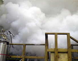 A cloud of helium gas billows out of a quenched superconducting magnet.