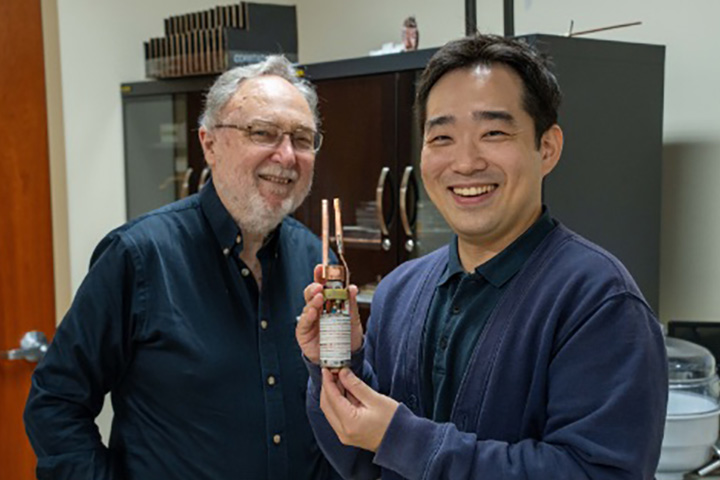 MagLab Chief Materials Scientist David Larbalestier and researcher Jeseok Bang (holding coil).