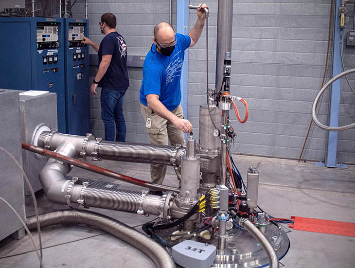 MagLab researchers Troy Brumm and Robby Nowell prepare the SCM-32 T for users.