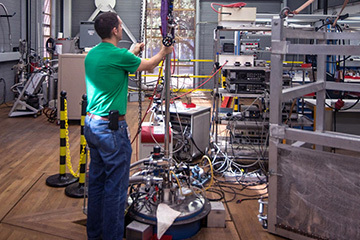 MagLab Scientist lowering a probe into millikelvin Magnet