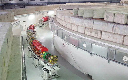The synchrotron's main ring during installation.