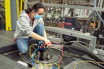 MagLab Scientist adjusting probe connections on the 36 Tesla Series Connected Hybrid