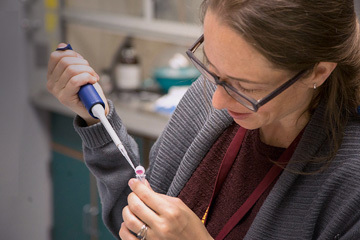 Visiting scientist using a syringe to load a sample