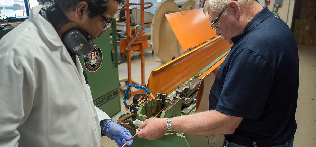 Research scientists Shreyas Balachandran (left) and William Starch draw lengths of niobium-tin superconducting wire at the Applied Superconductivity Center at the National High Magnetic Field Laboratory. A new grant of $1.5 million will allow the group to continue this research.