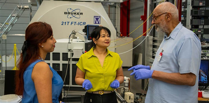 Postdoctoral researcher Grisel Fierros-Romero (left), MagLab faculty researcher Huan Chen (center) and FAMU professor Henry N. Williams (right) in front of the 21-tesla Fourier-Transform Ion Cyclotron Resonance mass spectrometer at the MagLab.