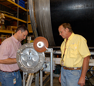 Lee Marks (left) and Scott Bole with the machine they invented.