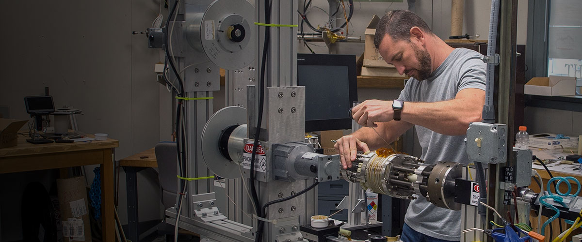 Engineer winding a superconducting magnet
