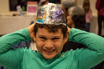 A boy in a brain cerebrum hat