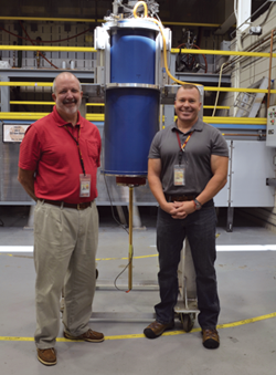 Scientists Eric Palm (left) and Tim Murphy in front of the dilution fridge, part of the 45 tesla magnet.