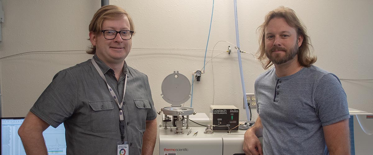 Geochemists Seth Young (left) and Jeremy Owens with the MagLab's Thermo elemental analyzer and isotope ratio mass spectrometer, which measured sulfur isotopes in their samples. Their data made clear the connections between historic changes in ocean oxygen levels and mass extinction of marine organisms.