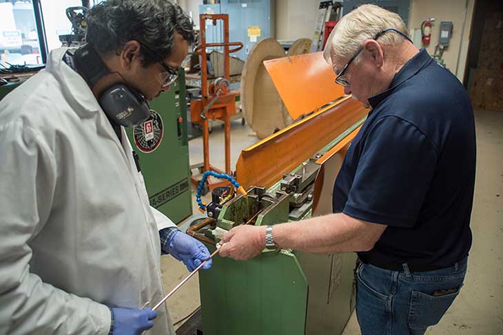 Research scientists Shreyas Balachandran (left) and William Starch draw lengths of niobium-tin superconducting wire at the Applied Superconductivity Center at the National High Magnetic Field Laboratory. They are working to increase the amount of current the wire can carry to enable the creation of stronger magnets.