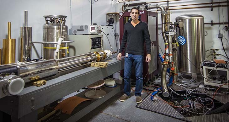 Bridge Fellow Aidan Zabalo in the lab with the probe he built for his research project.