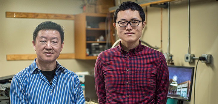 Wei Guo (left) with graduate student Toshiaki Kanai in the cryogenics lab at the National High Magnetic Field Laboratory.