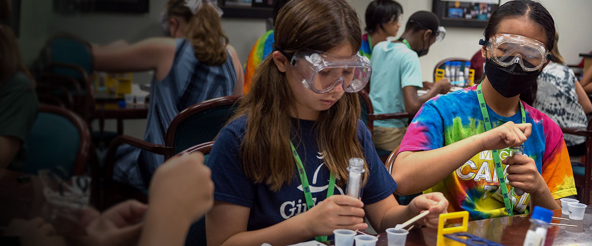 Summer camp attendees performing an experiment