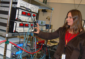 University of Pittsburgh scientist Daniela Bogorin adjusts an experiment on the fractional quantum hall effect in the Millikelvin Facility.