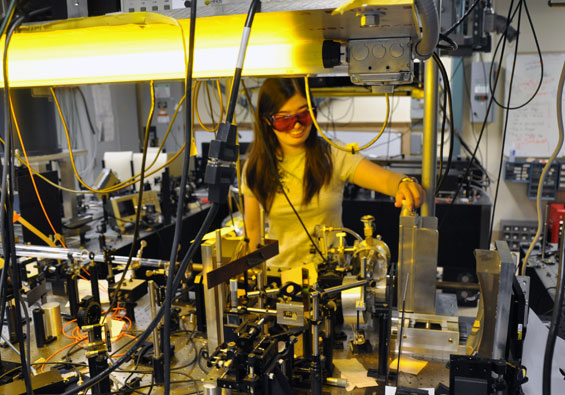 Postdoc Luyi Yang works on an optics experiment.
