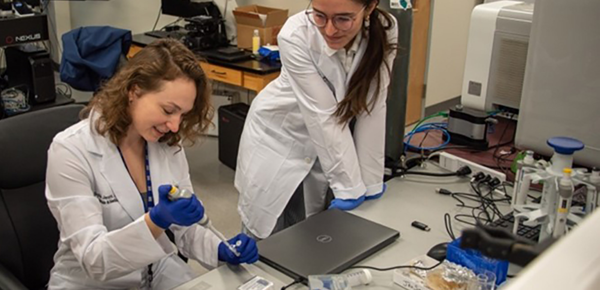Graduate students Sophie Jermyn (left) and Mary Jean Savitsky (right) working in professor Jamel Ali’s lab at the National High Magnetic Field Laboratory.
