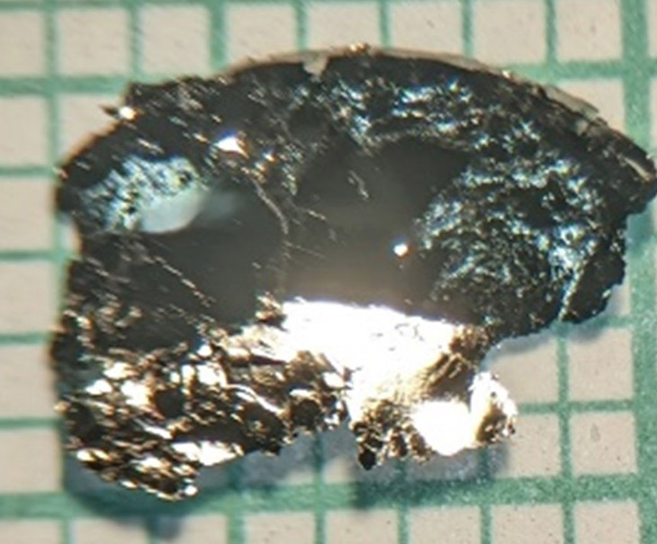A fragment of Fe5-xGeTe2, the synthetic crystalline compound of iron, germanium, and tellurium in which the magnetic vortices were detected and measured.