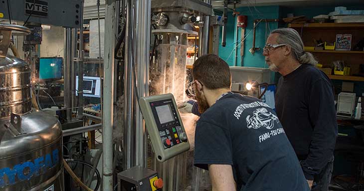 Materials scientists Kyle Radcliff (left) and Bob Walsh conduct low-temperature tensile tests to determine the performance and reliability of materials used in cryogenic superconducting magnets.