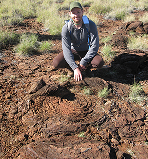 Researcher Chad Ostrander with a 2.7 billion-year-old fossilized stromatolite in Western Australia - strong evidence that they did indeed exist.