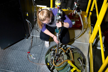 User lowering probe into the 100T at Los Alamos Site